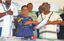 ?? PHOTOS: SUPPLIED ?? DFFE Deputy Minister Makhotso Magdeline Sotyu hands over a signed Community Forestry Agreement to the Imidushane Traditiona­l Council represente­d by Chief Mekeni Phikisa. Sotyu with Chief Manzolwand­le Sandile of Manqabe Traditiona­l Authority.