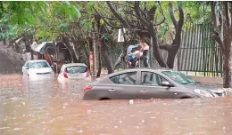  ?? —ANIL KUMAR ?? Cars lie half submerged after the rains in the city.