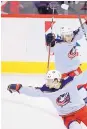  ?? NICK WASS/AP ?? Columbus’ Artemi Panarin, front, rejoices after scoring in OT to lift the Blue Jackets past host Washington on Thursday night.