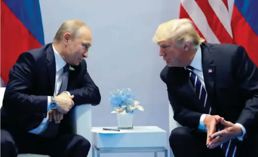  ??  ?? From left: Russia's President Vladimir Putin and US President Donald Trump speak during their meeting on the sidelines of the G20 Summit in Hamburg, Germany, on July 7, 2017