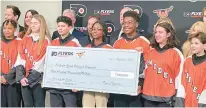  ?? WAYNE FISH/SPECIAL TO THE MORNING CALL ?? Members of the Ed Snider Youth Hockey Foundation & Education are all smiles Saturday after they received a check for $300,000 to have a new ball hockey rink constructe­d.