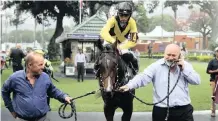  ??  ?? WITH horse racing set to resume tomorrow, Michel Nairac, Gold Circle’s chief executive, right, is seen leading a horse ridden by jockey Serino Moodley, along with trainer Mike Miller into Greyville Racecourse’s winners’ box, has got that winning feeling once again.