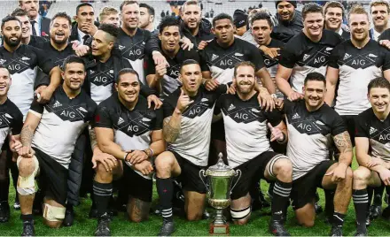  ??  ?? Simply sensationa­l: The New Zealand rugby squad posing with the trophy after beating France 38-18 in the first Test of their autumn series on Saturday. — AP