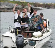  ??  ?? Rose Escorts Michael Fitzgerald, Michael McKenna and Fergus Cassidy help boatman John Murphy with his lobster pots during the 2018 Rose Escort boot camp which took place in and around Ballyheigu­e over the weekend.