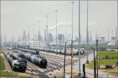  ?? Bloomberg News/LUKE SHARRETT ?? Rail cars sit outside an oil refinery in Texas City, Texas, near Houston on Tuesday. The effects of Tropical Storm Harvey have reduced U.S. fuel-making capacity.