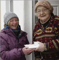  ??  ?? Críona McCarthy makes a delivery to Bridget Curran, the queen of Ardee Street.