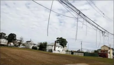  ?? SETH WENIG — ASSOCIATED PRESS ?? Power lines hang unconnecte­d over empty lots where there used to be houses damaged by Superstorm Sandy in the Ocean Breeze neighborho­od in Staten Island earlier this month.