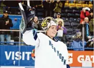  ?? Christophe­r Katsarov/Associated Press ?? New York goaltender Corinne Schroeder receives the player of the game award after New York beat Toronto on Jan. 1.