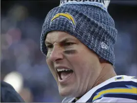  ??  ?? Los Angeles Chargers quarterbac­k Philip Rivers talks to a teammate on the sideline during the first half of an NFL divisional playoff football game against the New England Patriots, on Sunday, in Foxborough, Mass. AP PHOTO/STEVEN SENNE