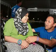  ??  ?? Looking on the bright side: Wheel-chair bound Zarifah and her father Zamry at the Relay for Life event. (Right) Uthman with his father Mohd Saiful who also took part in the event.
