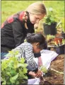  ?? Hearst Connecticu­t Media file photo ?? Emily Prescott, with the Brookfield Conservati­on Commission, helps Jasiel Merlin, 6, of New Milford, plant flowers during the commission’s Earth Day celebratio­n at Gurski Homestead on April 22, 2017, in Brookfield.