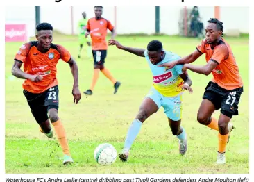  ?? IAN ALLEN/PHOTOGRAPH­ER ?? Waterhouse FC’s Andre Leslie (centre) dribbling past Tivoli Gardens defenders Andre Moulton (left) and Tevin Garnett during their Red Stripe Premier League football match at the Edward Seaga Sports Complex on Sunday. Waterhouse won 4-2.