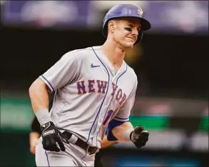  ?? Alex Brandon / Associated Press ?? New York Mets’ Mark Canha rounds the bases for his solo home during the ninth inning against the Washington Nationals at Nationals Park on Thursday in Washington.