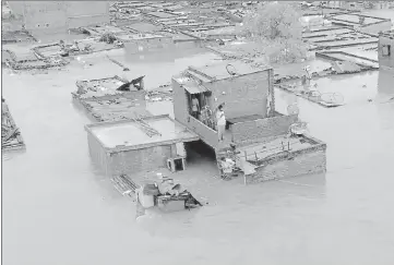  ?? ?? Houses get submerged in floodwater in Rudrapur, in US Nagar district on Tuesday.