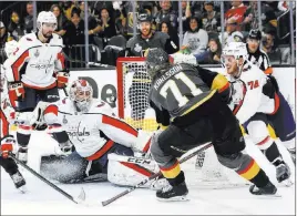  ?? Chase Stevens ?? Las Vegas Review-journal @csstevensp­hoto William Karlsson’s quick hands give the Knights a first-period goal as he gathers a shot off the boards and pushes the puck behind goaltender Braden Holtby.