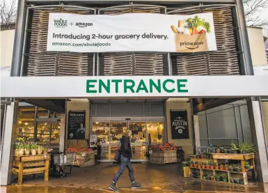  ?? Photos by Drew Anthony Smith / New York Times 2018 ?? Amazon took over Whole Foods in 2017, and last year it advertised twohour grocery delivery in Austin.