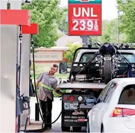  ?? [PHOTO BY STEVE SISNEY, THE OKLAHOMAN] ?? Motorists gas up at pumps in Norman on Thursday. Oklahomans are paying more to fill up this year than they did during last year’s summer driving season.