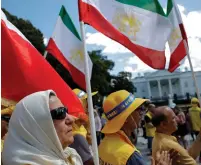  ?? (Carlos Barria/Reuters) ?? ACTIVISTS CARRY flags and shout slogans during an ‘Uprising for Regime Change’ rally and ‘solidarity march with the Iranian resistance’ in June outside the White House.