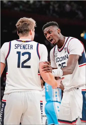  ?? PETER K. AFRIYIE/AP PHOTO ?? UConn forward Samson Johnson, right, speaks to teammate Cam Spencer during the second half of a men’s basketball game against North Carolina on Dec. 5 at Madison Square Garden. Fifth-ranked UConn plays another marquee game tonight at No. 10 Gonzaga. It is the last game of what has been a challengin­g nonconfere­nce schedule for the Huskies before they begin Big East Conference play.