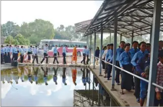  ?? SOK HENG NHET/ECCC ?? Students and monks queue up outside public gallery of the Khmer Rouge tribunal late last year.