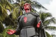  ?? Lynne Sladky / Associated Press ?? A statue of Christophe­r Columbus stands vandalized at Bayfront Park in Miami on Thursday. Miami police say several people were arrested.