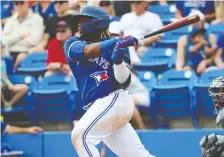  ?? KIM KLEMENT/USA TODAY SPORTS ?? Blue Jays third baseman Vladimir Guerrero Jr. raps out a single during the third inning of a 4-3 spring training win over the Atlanta Braves on Monday at TD Ballpark in Dunedin, Fla.