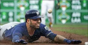  ?? GENE J. PUSKAR — THE ASSOCIATED PRESS ?? Manny Pina of the Milwaukee Brewers slides safely into third for a triple off Pittsburgh Pirates starting pitcher Jameson Taillon in the second inning Tuesday night at PNC Park. Pina had two hits as the Brewers held on to beat the Pirates, 3-2.