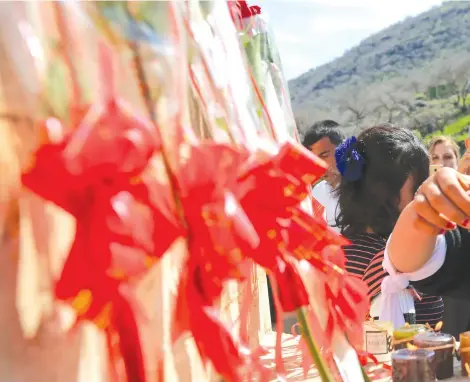  ?? (Photos: Reuters) ?? A YAZIDI woman lights candles during a ceremony at Lilash Temple to commemorat­e the death of women killed by ISIS, on Internatio­nal Women Day in Shikhan, north of Iraq, on March 8.