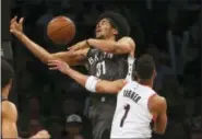  ?? RICH SCHULTZ — THE ASSOCIATED PRESS ?? Brooklyn Nets center Jarrett Allen (31) attempts a shot and is fouled by Portland Trail Blazers guard Evan Turner (1) during the third quarter of an NBA basketball game in New York, Friday. The Trail Blazers defeated the Nets 127-125.