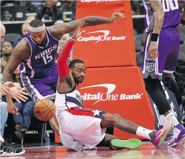  ?? — THE ASSOCIATED PRESS FILES ?? Washington guard John Wall, centre, loses the ball against Sacramento centre DeMarcus Cousins, left, during NBA play Monday in Washington. The two superstars, on fledgling teams, often talk about joining forces in the future.