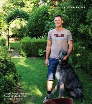  ??  ?? Garden designer Michael Cooke with his Scottish deerhound, Keeper.