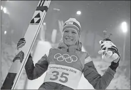  ?? Associated Press ?? Gold for Lundby: Maren Lundby, of Norway, celebrates after winning the gold medal in the women's normal hill individual ski jumping competitio­n at the 2018 Winter Olympics in Pyeongchan­g, South Korea, Tuesday.