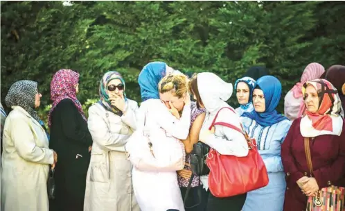  ??  ?? Relatives of suicide bombing victim Mohammad Eymen Demirci at his funeral on Wednesday in Istanbul. The Turkish government and Western officials said the suicide bombings at Istanbul’s main airport on Tuesday bore the hallmarks of an Islamic State attack. Credit Ozan Kose/Agence France-Presse — Getty Images