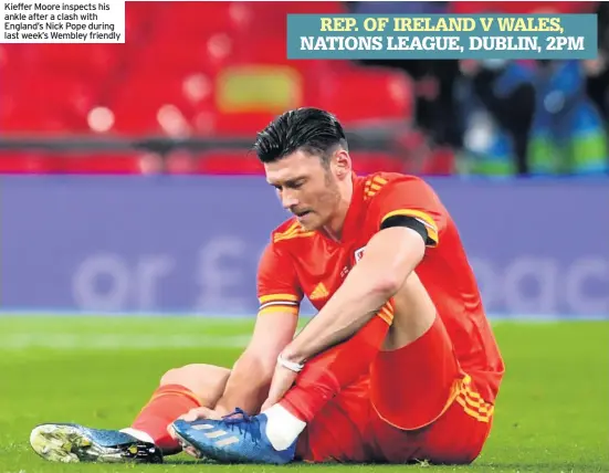  ??  ?? Kieffer Moore inspects his ankle after a clash with England’s Nick Pope during last week’s Wembley friendly