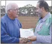  ??  ?? Farmer Rusty Mitchell and HAA chairman Riyad Qasim in Cobar. PHOTO: SUPPLIED