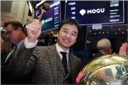  ??  ?? Mogu Inc. co-founder, Chairman and CEO Shark Chen rings a ceremonial bell as his company’s IPO begins trading on the floor of the New York Stock Exchange, Thursday, Dec. 6.