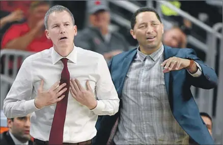  ?? Ethan Miller Getty Images ?? USC HEAD COACH Andy Enfield, left, hasn’t been named in any of the publicized parts of the FBI probe into college basketball corruption, but associate head coach Tony Bland was fired after it was alleged that he took $13,000 from a would-be agent.