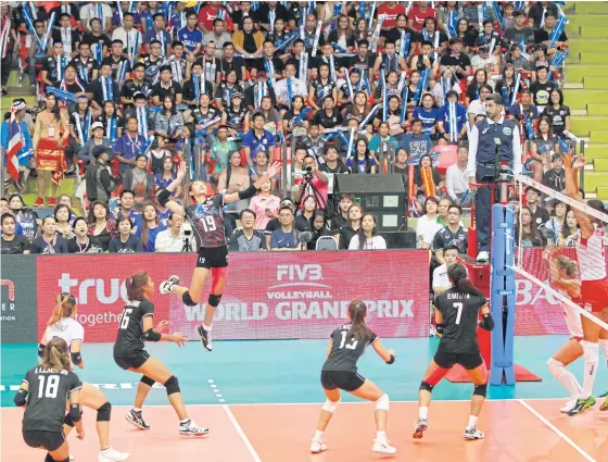  ??  ?? Thailand’s Chatchu-on Moksri spikes the ball against Turkey during their Pool H1 game at Hua Mark Indoor Stadium.