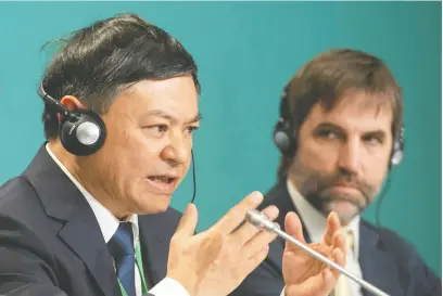  ?? GRAHAM HUGHES/THE CANADIAN PRESS ?? Minister of Environmen­t and Climate Change Steven Guilbeault looks on in Montreal on Tuesday as Huang Runqiu, president, COP15 and minister of ecology and environmen­t of China, speaks at the opening news conference of COP15, the UN Biodiversi­ty Conference.