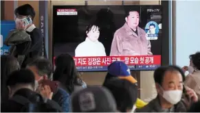  ?? ?? Take your daughter to work day: A news programme showing an image of Kim and his child at the Seoul Railway Station. — AP