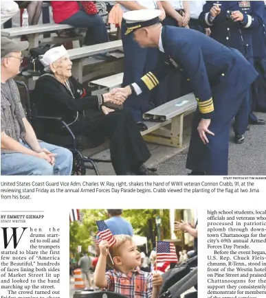  ?? STAFF PHOTOS BY TIM BARBER ?? United States Coast Guard Vice Adm. Charles W. Ray, right, shakes the hand of WWII veteran Connon Crabb, 91, at the reviewing stand Friday as the annual Armed Forces Day Parade begins. Crabb viewed the planting of the flag at Iwo Jima from his boat....