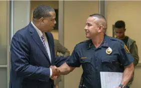  ?? Benjamin B. Braun/Post-Gazette ?? Mayor Ed Gainey shakes Police Chief Larry Scirotto’s hand and compliment­s him after a news conference regarding the release of a staffing report for the Pittsburgh Bureau of Police on July 19, 2023.