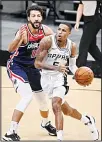  ??  ?? San Antonio Spurs’ Dejounte Murray, (right), drives around Washington Wizards’ Anthony Gill during the first half of an NBA basketball game, Jan 24, in San Antonio. (AP)