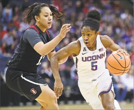  ?? David Dermer / Associated Press ?? UConn’s Crystal Dangerfiel­d drives on Stanford's Marta Sniezek during the first quarter Sunday in Columbus, Ohio.