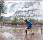  ?? Eric Paul Zamora Fresno Bee ?? KEVIN KIMO LAUGHLIN wades back to dry ground from the Merced River on Saturday.