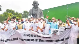  ??  ?? Congress leader Rahul Gandhi with party leaders and MPs from DMK and other parties at a protest on the Pegasus issue, near the Gandhi statue in Parliament on Friday.