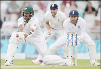  ??  ?? England’s Jonathan Bairstow (right), looks on as Pakistan’s Wahab Riaz plays a shot on the third day of the second Test cricket match between England and Pakistan at Old Trafford Cricket Ground in Manchester, northwest England,
on July 24. (AFP)