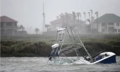  ?? Photograph: Annie Rice/AP ?? A boat sinks in the Packery Channel during Hurricane Hanna, in North Padre Island, Texas.