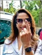  ?? PTI ?? Actress Madhuri Dixit shows her inked finger after casting her vote for Maharashtr­a Assembly elections