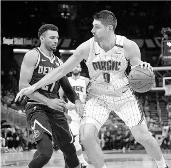  ?? PHELAN M. EBENHACK/AP ?? Magic center Nikola Vucevic (9) said the team’s road to Mexico City should provide few distractio­ns as the team tries to get back on track.